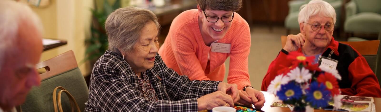 team member assisting elderly woman