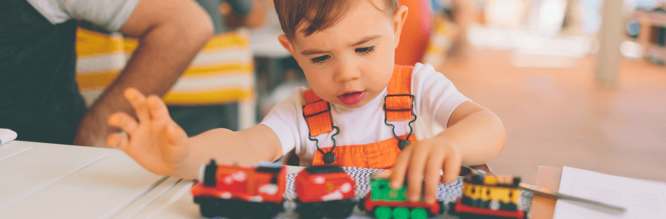 child playing with train set