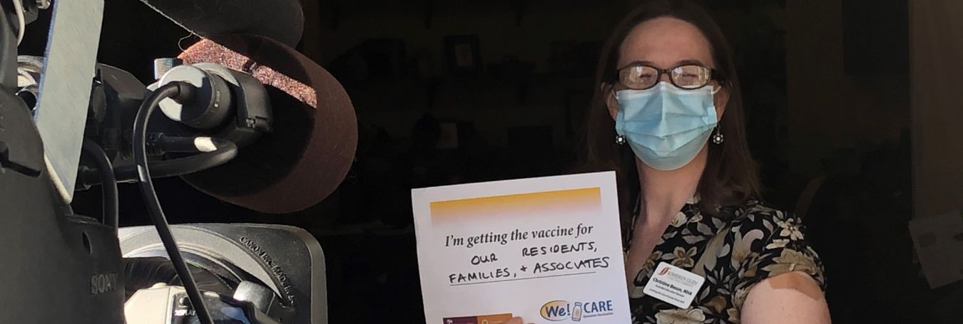 Caregiver poses after receiving COVID-19 vaccine.