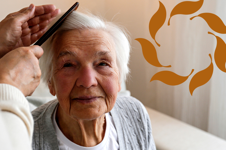 Older adult women smiling as her hair is combed