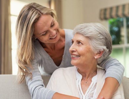 Memory Care Colorado Springs Daughter hugging mother on couch