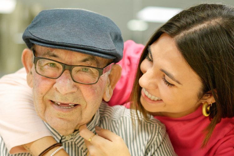 older man and daughter hugging