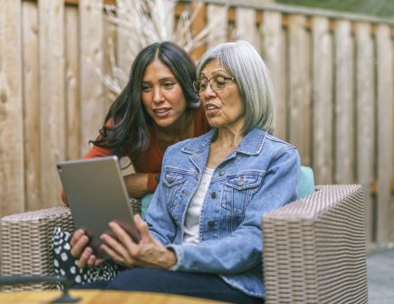 Senior woman learning to use tablet computer with the help of her adult daughter | Sunny Vista Senior Living Colorado Springs