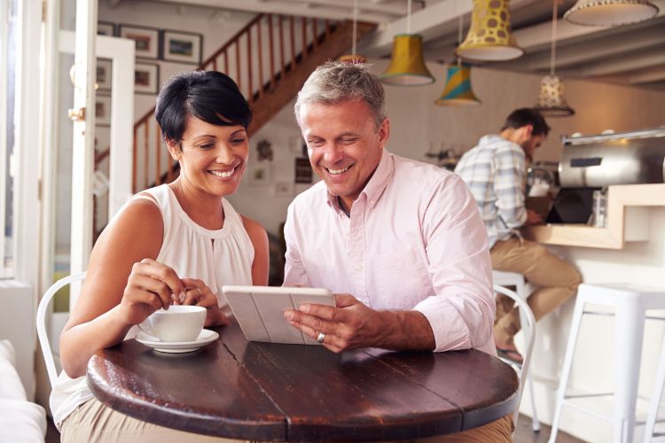 Smiling couple sitting together at coffee shop